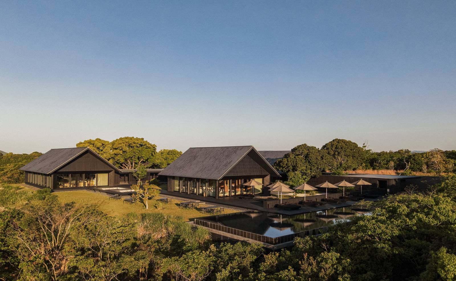 安縵伊沐的黑瓦屋頂建築群與周圍樹林的空拍