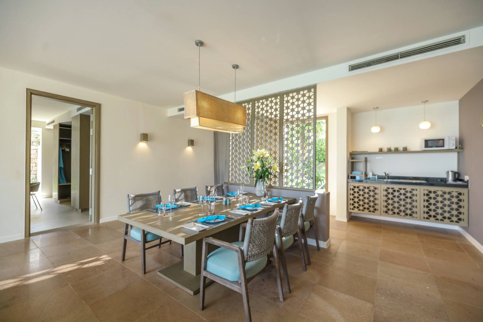 芽莊 Mia 度假村 Ocean View Two-Bedroom Villa 開放式客廳與餐桌,石牆與木作面向戶外光線