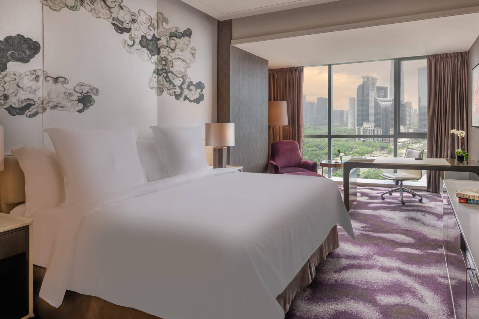 深圳四季酒店 Deluxe Room 的大床與城市窗景