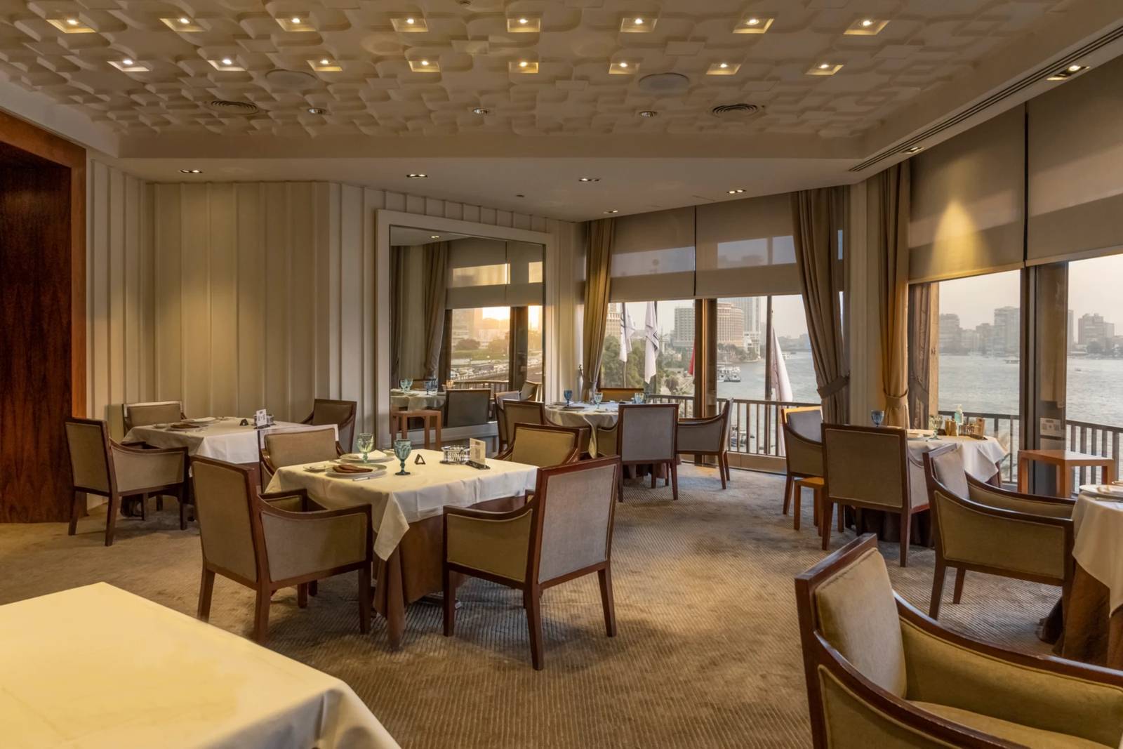 開羅塞米勒米斯洲際酒店 The Grill 的餐桌座位與面向尼羅河的大窗