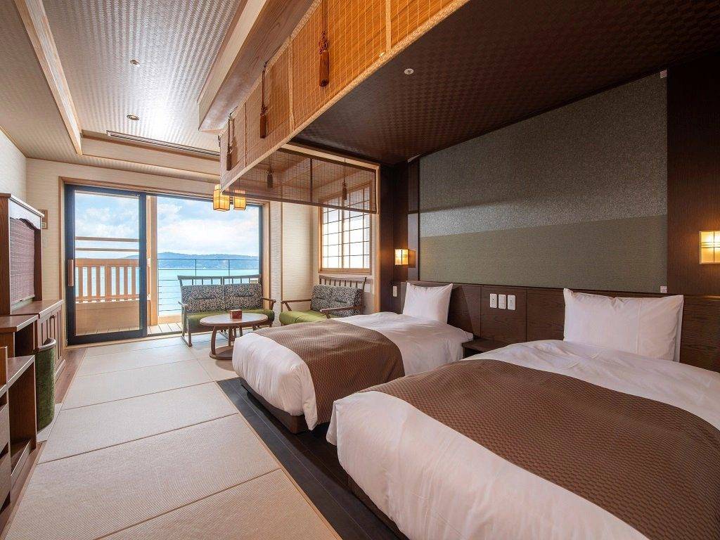 能登 海舟和洋四人房起居間的兩張床與海景陽台